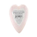 Heart-shaped pink bath bomb with strawberry champagne scent and label describing a hidden vibrating toy inside.
