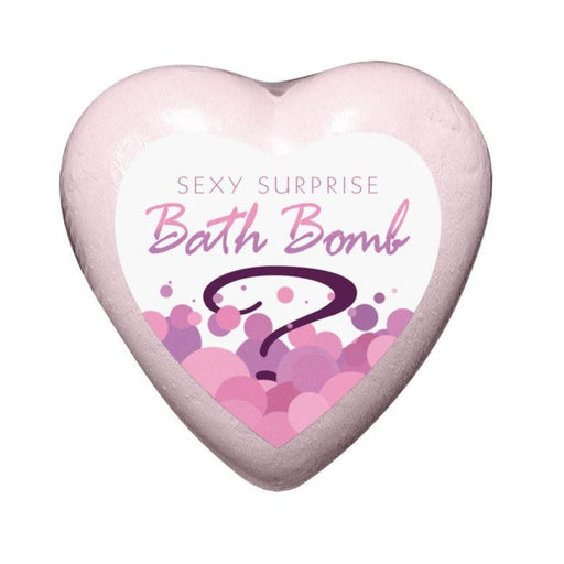 Heart-shaped pink bath bomb with a label reading Sexy Surprise Bath Bomb and decorative pink bubbles.