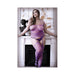 Plus size model wearing sheer purple strappy garter bodystocking with intricate patterns, posing by a white mantelpiece.