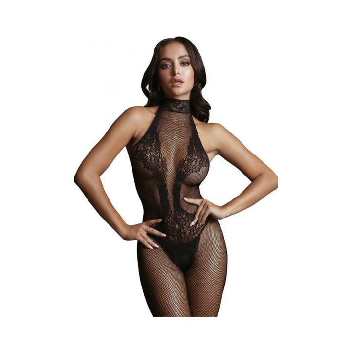 Woman wearing a black fishnet and lace high-neck bodystocking with halter design and floral lace accents.