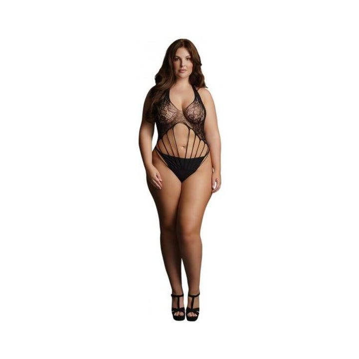 Plus-size model wearing black strappy lace teddy with halter neck and cut-out design, paired with black heels.