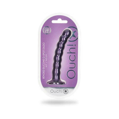 Metallic purple beaded silicone G-spot dildo with suction base in clear packaging on purple background.