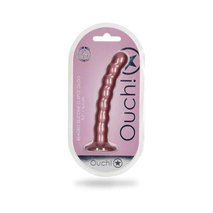 Rose gold beaded silicone G-spot dildo with suction base in clear packaging on a pink background.