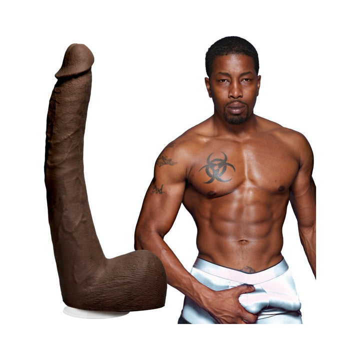 Chocolate-colored realistic dildo with suction cup next to a shirtless muscular man in silver shorts.
