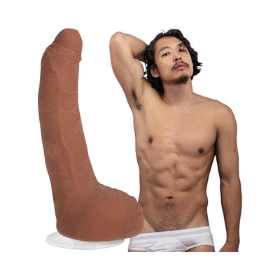 Caramel-colored realistic 6-inch ULTRASKYN dildo with suction cup beside shirtless male model in white briefs.