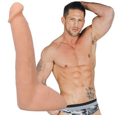 Vanilla-colored lifelike 8-inch Ultraskyn dildo with suction cup displayed next to shirtless muscular man in camo underwear