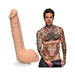 9 inch lifelike vanilla Ultraskyn dildo with suction cup next to tattooed male model in Calvin Klein underwear