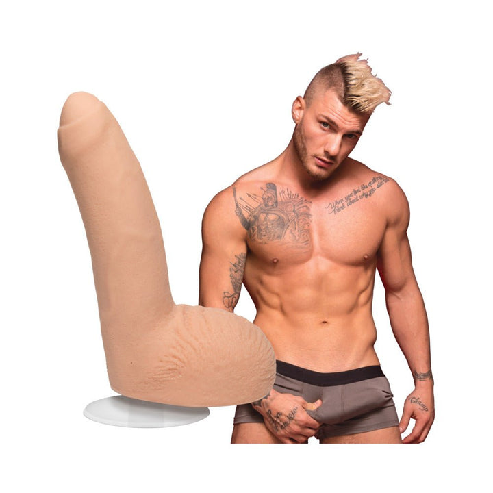 Realistic 8-inch flesh-toned dildo with suction base beside a tattooed muscular man in gray underwear.