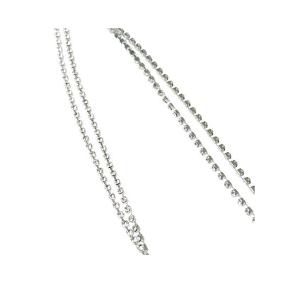 Close-up of double-stranded silver cubic zirconia jeweled nipple clips chain on white background.