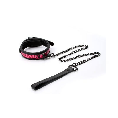 Adjustable black collar with pink padded interior and attached black metal chain leash with leather handle on white background.