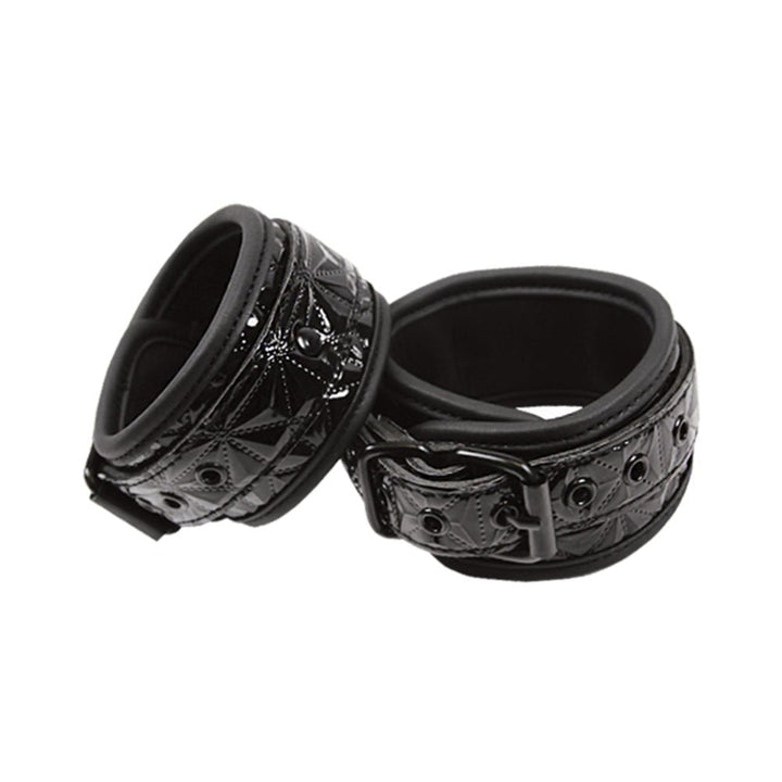 Pair of black embossed vinyl wrist cuffs with soft neoprene lining and adjustable buckle closures.