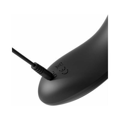 Close-up of black silicone cock teaser with USB charging cable plugged in.