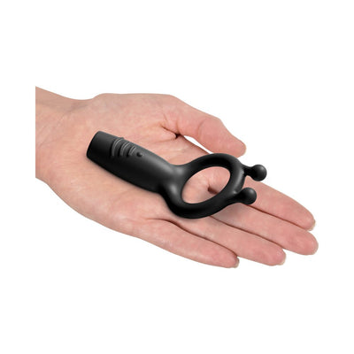 Black silicone vibrating super C-ring displayed on an open hand showing size and design details.