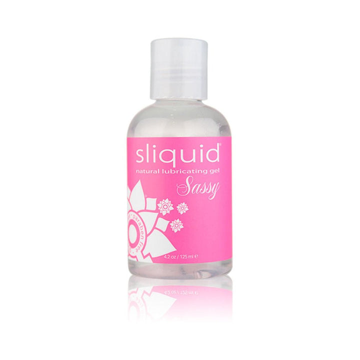 Clear bottle of Sliquid Sassy natural lubricating gel with pink label and white floral design, 4.2oz size.