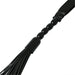 Close-up of black faux leather flogger with smooth wooden beads on the handle and multiple thin tails.