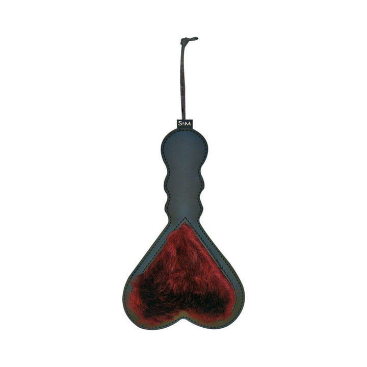 Black paddle with a red furry heart detail and a wrist strap for easy handling.