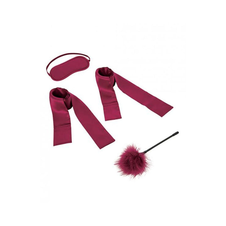 Burgundy satin blindfold, matching wrist restraints, and a feather tickler from the S&M Enchanted Starter Kit.