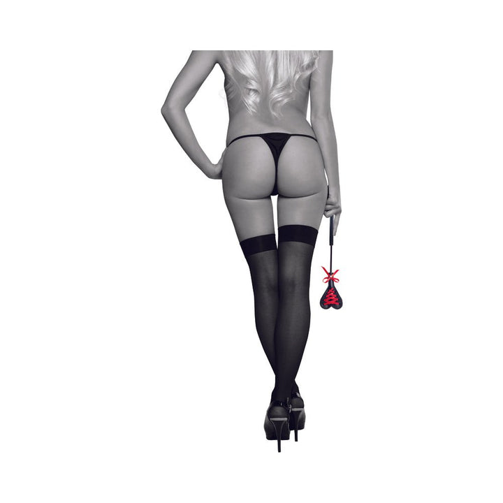 Rear view of a woman in black stockings and heels holding the S&M Heart Beat Crop with a red lace heart and bow detail.