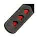 Close-up of black vegan leather paddle with three red heart-shaped cutouts.