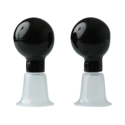 Pair of black bulb-style nipple suckers with clear flanged bases for adjustable suction and secure fit.