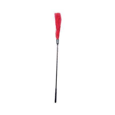 S&M rubber tickler with long black handle and red rubber strands for sensory play and tactile stimulation.