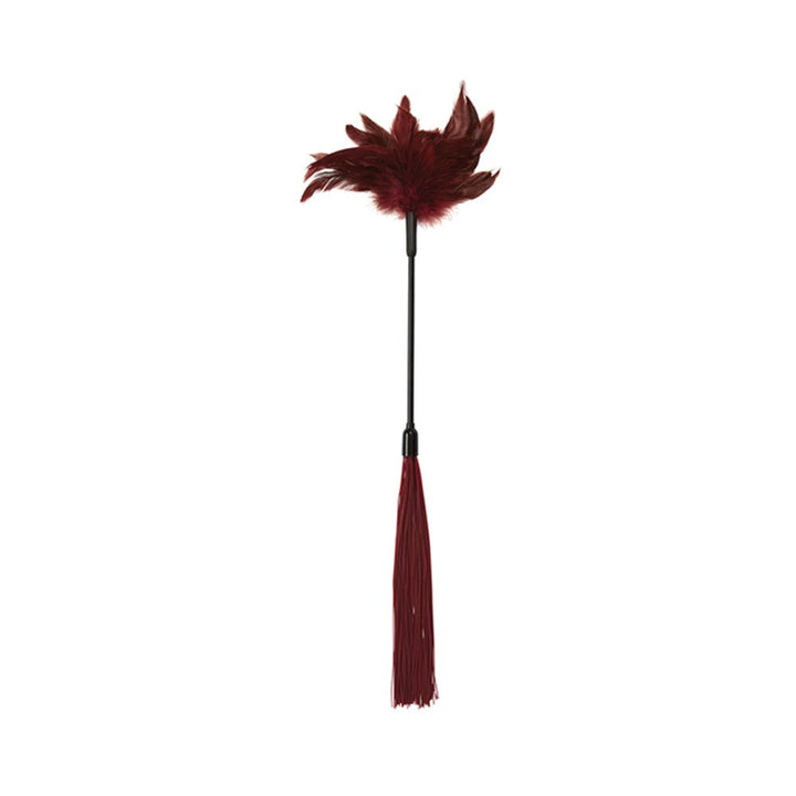 Red feather tickler with soft feathers on one end and silicone strands on the other, designed for sensory play.