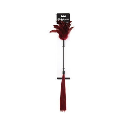 Red feather tickler with silicone strands on a black handle, packaged on a white backing card.