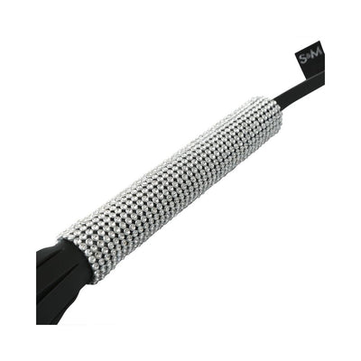 Close-up of a black flogger handle adorned with sparkling silver rhinestones for a stylish grip.