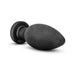 Large black silicone plug with carbon fiber texture and suction cup base on white background.