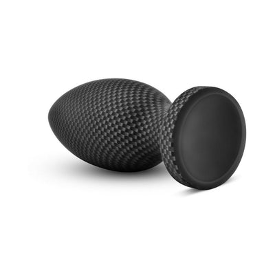 Small carbon fiber textured silicone plug with tapered tip and wide suction cup base on white background.