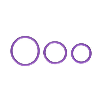 Set of three purple flexible silicone cock rings in varying sizes displayed on a white background.