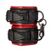 Pair of black and red padded vegan leather Sportsheets Saffron adjustable handcuffs with metal clasps and D-rings.