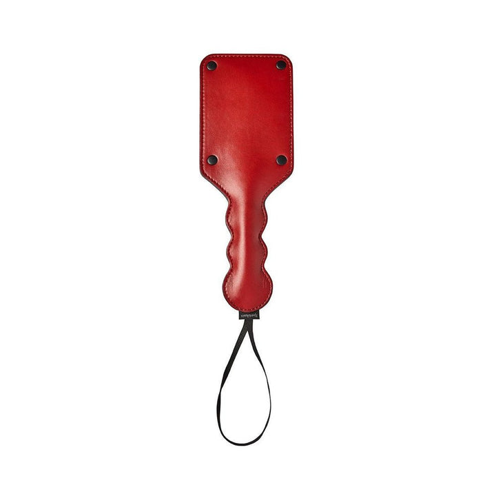 Red vegan leather paddle with black rivets and wrist loop, featuring a contoured handle for secure grip.