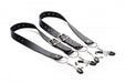 Black adjustable labia spreader straps with metal clamps and buckles on a white background.