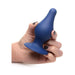 Hand holding a blue squeezable tapered large anal plug with a wide suction cup base against a white background.