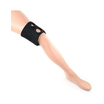 Black neoprene dual penetration thigh strap-on harness displayed on a mannequin leg with two reinforced O-rings.
