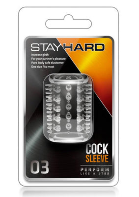 Clear textured Stay Hard cock sleeve in retail packaging with black and orange design accents.