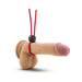 Adjustable red silicone loop cock ring with black locking slide shown on a realistic male anatomy model.