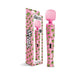 Pink wand massager with green weed leaf pattern and matching packaging, featuring dual-speed control button.
