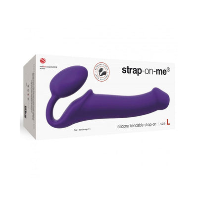 Purple silicone bendable strap-on displayed on white packaging box with strap-on-me branding and size L label.