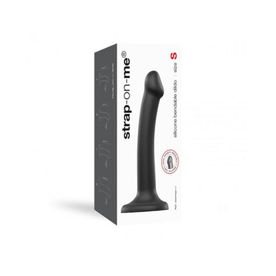 Small black dual density bendable silicone dildo with suction base shown next to its white and black packaging box.