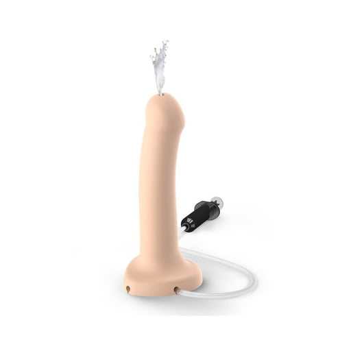 Large semi-realistic silicone dildo with a tube and syringe for customizable fluid release, shown with liquid spray effect.