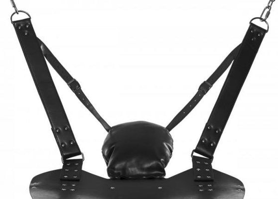 Black leather bondage sling with padded pillow and adjustable stirrup straps suspended by metal chains.