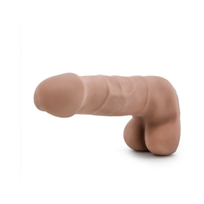 Realistic skin-toned flexible adult toy with textured surface and attached testicles on white background.