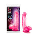 Transparent pink realistic dildo with suction cup base shown in and out of packaging.