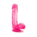 Transparent pink beginner dildo with suction cup base and realistic texture, standing upright on white background.