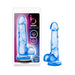 Blue translucent realistic dildo with suction base shown in and out of packaging.