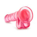 Pink translucent realistic dildo with suction cup base angled on white background.
