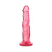 Pink translucent realistic dildo with suction cup base standing upright on white background