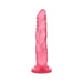 Pink translucent realistic dildo with suction cup base standing upright on white background
